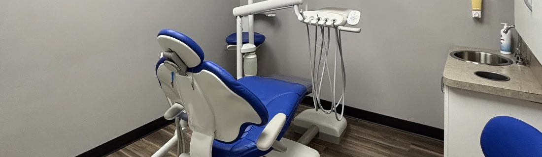 Dentist Lawrenceville GA General Dentistry Focused dental examination room with sink and dental tools and chair pictured